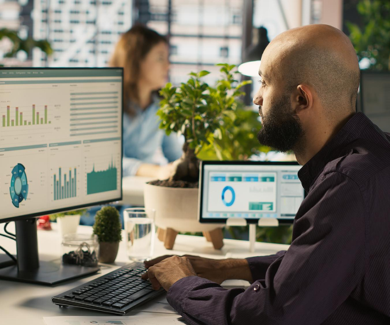 Two Ontrac operators reviewing revenue dashboards